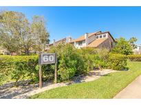 Inviting condo exterior with lush landscaping and a clear building number sign at 60 N Halifax Dr # 1050, Ormond Beach, FL 32176