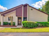 Charming condo featuring a well-manicured lawn, trimmed hedges, and a cozy front entrance at 101 Grand Plaza Dr # G60, Orange City, FL 32763