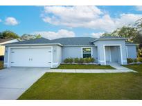 Charming one-story home with a well-maintained lawn, an attached garage, and a welcoming entrance at 1162 Prescott Blvd, Deltona, FL 32738