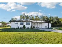 Charming single-story home with a well-maintained lawn and inviting front porch at 1265 Aquarius Ave, Deland, FL 32724