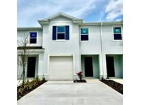Modern townhome features a one-car garage and minimalist landscaping in the front yard at 131 Reena Dr, Daytona Beach, FL 32117