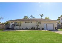 Charming single-story home with a well-manicured lawn and attached garage at 1551 7Th Ave, Deland, FL 32724
