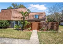Charming two-story home with well-kept lawn, wood fence, and mature landscaping for added privacy at 171 Moonstone Ct, Port Orange, FL 32129
