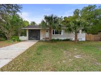 Charming single-story home with a well-maintained lawn and mature palm trees at 514 Land O Lakes Ct, Deland, FL 32724