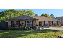 Charming single-story brick home with red shutters and well-manicured landscaping at 520 Dixson St, Orange City, FL 32763