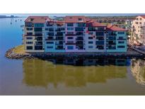 Multi-story waterfront condominium with private balconies and expansive water views in a coastal color palette at 732 Marina Point Dr # 7320, Daytona Beach, FL 32114