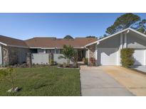 Charming home with a well-maintained lawn, stone accents, and an attached one-car garage at 120 Black Duck Cir, Daytona Beach, FL 32119