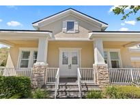 Inviting front entrance with stone accents, white railings, and double doors at 1205 Draycott St, Ormond Beach, FL 32174