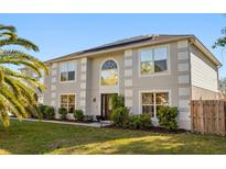 Two-story home featuring a well-manicured lawn and decorative landscaping at 2479 Vaughn Ave, Deltona, FL 32725