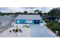 Charming blue single-story home featuring a white fence and a well-manicured front yard at 28 River Dr, Ormond Beach, FL 32176