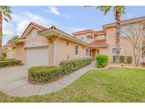 Charming home featuring a red tile roof, arched entry, manicured landscaping, and attached two-car garage at 3145 Connemara Dr, Ormond Beach, FL 32174