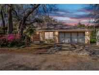 Charming brick home with attached two-car garage and mature landscaping at 50 Lake Dr # 1/2, Debary, FL 32713