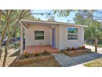 Charming home featuring a lovely brick patio and garden beds adding to its curb appeal at 709 Cedar St, Daytona Beach, FL 32114