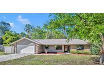 Charming single-story home with attached garage, brick accents, and well-maintained front lawn at 715 Oak Ter, Orange City, FL 32763