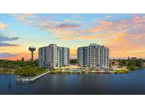 Stunning aerial view of two high-rise condos, featuring a pool, a pier, and gorgeous sunset at 935 N Halifax Ave # 309, Daytona Beach, FL 32118