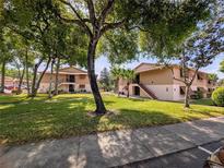 Well-maintained condo complex with mature trees and lush green lawns offers a serene setting for comfortable living at 190 Hickory Woods Ct # 15C, Deltona, FL 32725