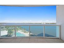 Enjoy this balcony view of the tranquil water, the in-ground pool, and lush landscaping from this condo at 241 Riverside Dr # 704, Holly Hill, FL 32117