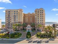 Luxurious beachfront condo building with lush landscaping and a grand entrance, offering upscale coastal living at 2515 S Atlantic Ave # 509, Daytona Beach, FL 32118
