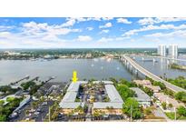 An aerial view of the property featuring bridge access, a waterfront, and plentiful parking at 411 N Halifax Ave # 304, Daytona Beach, FL 32118