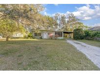 Charming single-story home with a well-maintained lawn and mature trees offering shade at 782 Valencia Ave, Orange City, FL 32763