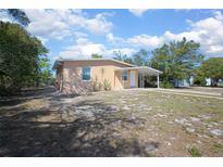 Charming single-story home featuring a covered carport and neutral stucco exterior at 954 Chippendale St, Deltona, FL 32725
