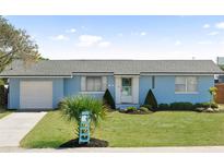 Charming one-story home with light blue paint, a well-manicured lawn, and tasteful landscaping at 111 Claire Ter, Daytona Beach, FL 32118