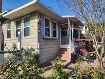 Charming home exterior with front porch, swing and brick steps at 503 5Th Ave, Daytona Beach, FL 32118