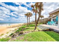 Stunning beachside home featuring a private deck with tranquil ocean views and palm trees at 787 Ocean Shore Blvd, Ormond Beach, FL 32176