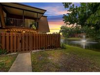 Charming condo overlooking a serene lake with a water fountain and lush landscaping, complete with a cozy upstairs balcony at 135 Moonstone Ct, Port Orange, FL 32129