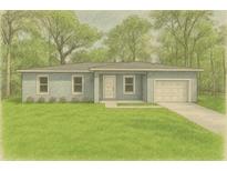 Charming single-story home featuring a well-maintained lawn and mature trees at 1450 Benham Ave, Orange City, FL 32763