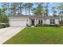 Charming one-story home featuring a two-car garage, well-manicured lawn, and inviting curb appeal at 1550 11Th Ave, Deland, FL 32724
