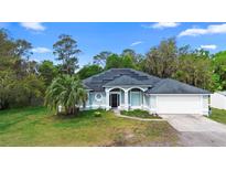 Charming single-Gathering home with solar panels, a well-manicured lawn, and a two-car garage at 2395 Old Reynolds Rd, De Leon Springs, FL 32130
