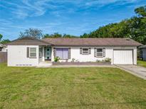 Charming single-story home with a well-manicured lawn and a quaint, inviting facade at 243 S Hull Ave, Deland, FL 32720