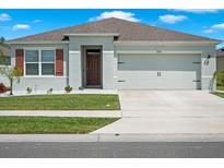 Charming single-story home with a well-manicured lawn, a two car garage, and a welcoming entrance at 2686 Neverland Dr, New Smyrna Beach, FL 32168