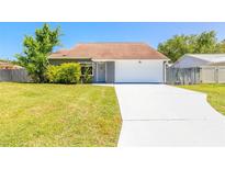 Charming single-story home featuring a well-maintained lawn and a spacious driveway leading to an attached garage at 2819 Silver Palm Dr, Edgewater, FL 32141