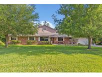 Charming brick home featuring a well-manicured lawn at 349 Evansdale Rd, Lake Mary, FL 32746