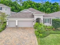 Charming single-story home with well-manicured landscaping and a brick paver driveway at 425 Wedgeworth Ln, Deland, FL 32724