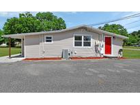 Charming single-story home with a red front door and cozy exterior at 430 S Woodward Ave, Deland, FL 32720