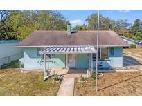 Charming home featuring a covered porch with unique architectural metal work and light blue siding at 630 Florida Ave, Daytona Beach, FL 32117