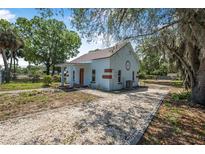 Charming single-story home with a gravel driveway and landscaped yard at 742 S Martin Luther King Blvd, Daytona Beach, FL 32114