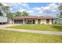 Charming single-story home with a well-maintained lawn and an inviting front porch at 792 Bennett Rd, South Daytona, FL 32119
