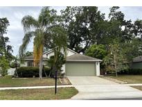 Charming one-story home featuring a well-manicured lawn and a two-car garage at 913 Lake Lindley N Dr, Deland, FL 32724