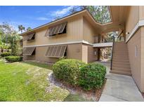 Charming two-story condo featuring shuttered windows and a well-maintained lawn at 110 Cypress Woods Ct # 2B, Deltona, FL 32725