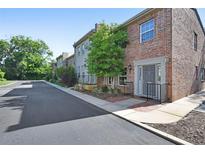 Attractive brick townhome featuring manicured landscaping and a private entryway at 117 N Garfield Ave # 16, Deland, FL 32724