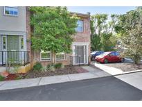 Charming brick townhome with well-maintained landscaping and dedicated parking spaces at 117 N Garfield Ave # 16, Deland, FL 32724