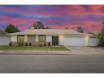 Charming single-story home with stone accents, double-door entry, well-manicured lawn, and a two-car garage at 1369 Saxon Blvd, Deltona, FL 32725