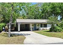 Charming single-story home featuring a covered carport, manicured lawn, and inviting curb appeal at 421 Hope Ter, Maitland, FL 32751