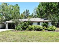 Charming single-story home with lush landscaping and a convenient carport in a well-manicured yard at 421 Hope Ter, Maitland, FL 32751