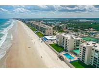 Breathtaking aerial view of beachside condos, sandy beach, and sparkling ocean at 4505 S Atlantic Ave # 505, Ponce Inlet, FL 32127