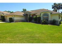 Charming single-story home with well-manicured lawn and lovely landscaping with a 2-car garage at 6182 Knotty Pine Ct, Port Orange, FL 32127